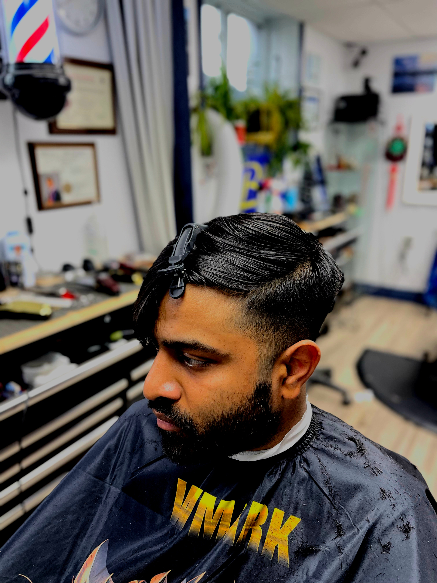 Textured side-part fade finished at the chair